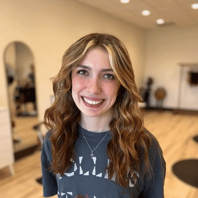 Portrait of Alexis, a professional stylist at Sisu Hair Studio, showcasing their expertise and style.