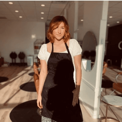 Portrait of Sarah, a professional stylist at Sisu Hair Studio, showcasing their expertise and style.