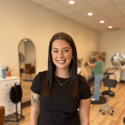 Portrait of Bella, a professional stylist at Sisu Hair Studio, showcasing their expertise and style.